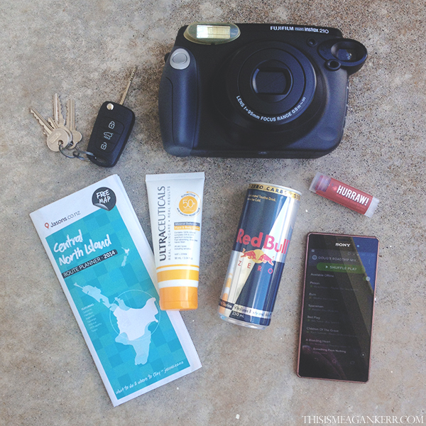 My roadtrip essentials include my Fujifilm NZ Instax Wide 210, a map so I can plan my trip, Ultraceuticals SunActive SPF 50+ Mineral Face & Body Lotion, Red Bull Zero, Hurraw! Balm Black Cherry Tinted Lip Balm and a Spotify playlist