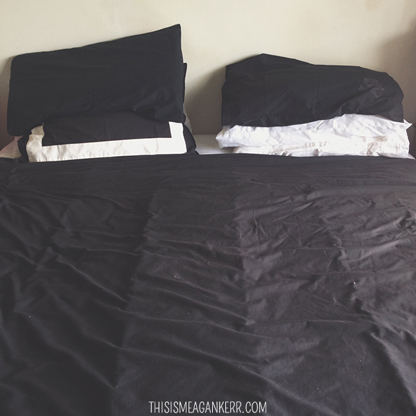 Made bed with black covers