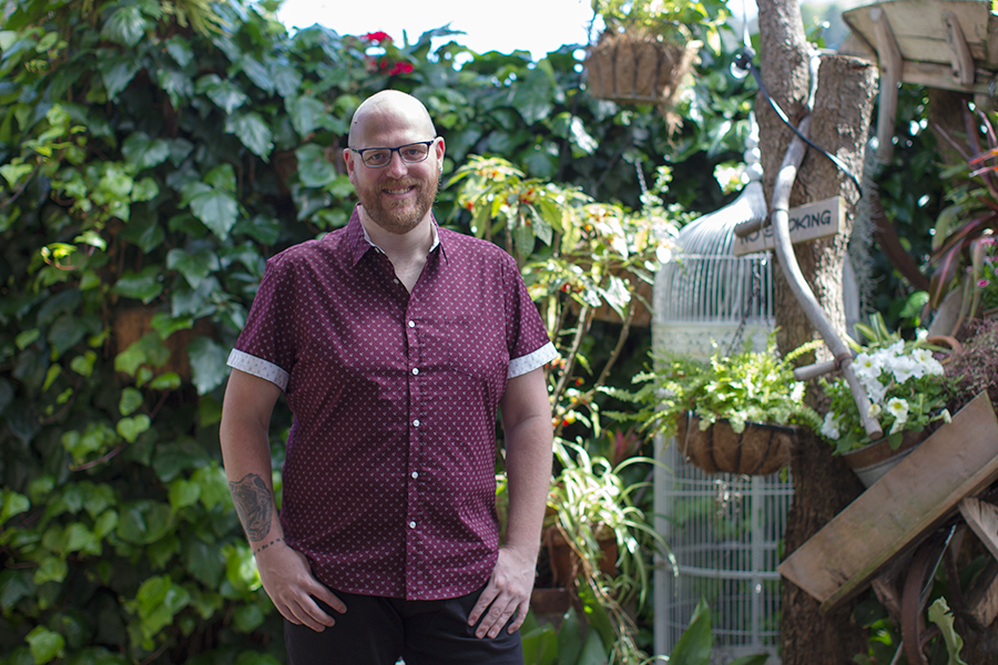 Big and tall menswear for parties: Doug Peters wears Marling Stretch Print Shirt, Steve Stretch Denim Shorts and Essential Trainers from Johnny Bigg at The Garden Shed