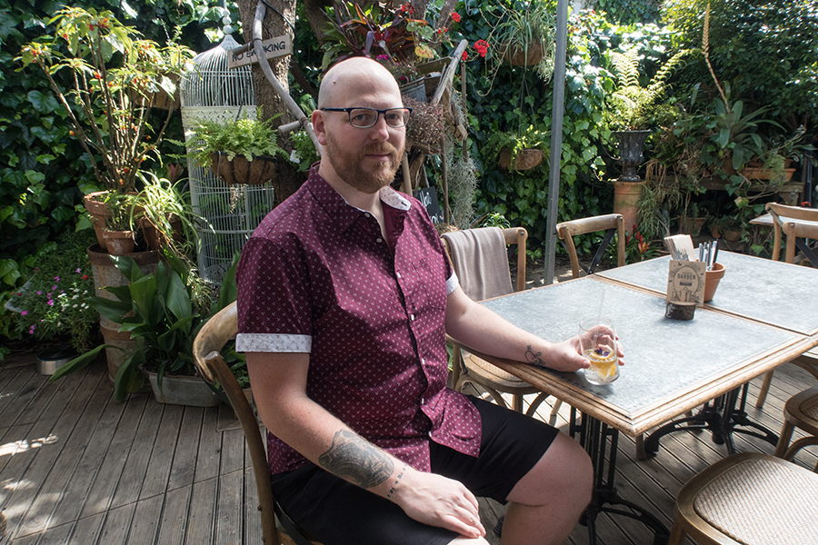 Big and tall menswear for parties: Doug Peters wears Marling Stretch Print Shirt, Steve Stretch Denim Shorts and Essential Trainers from Johnny Bigg at The Garden Shed