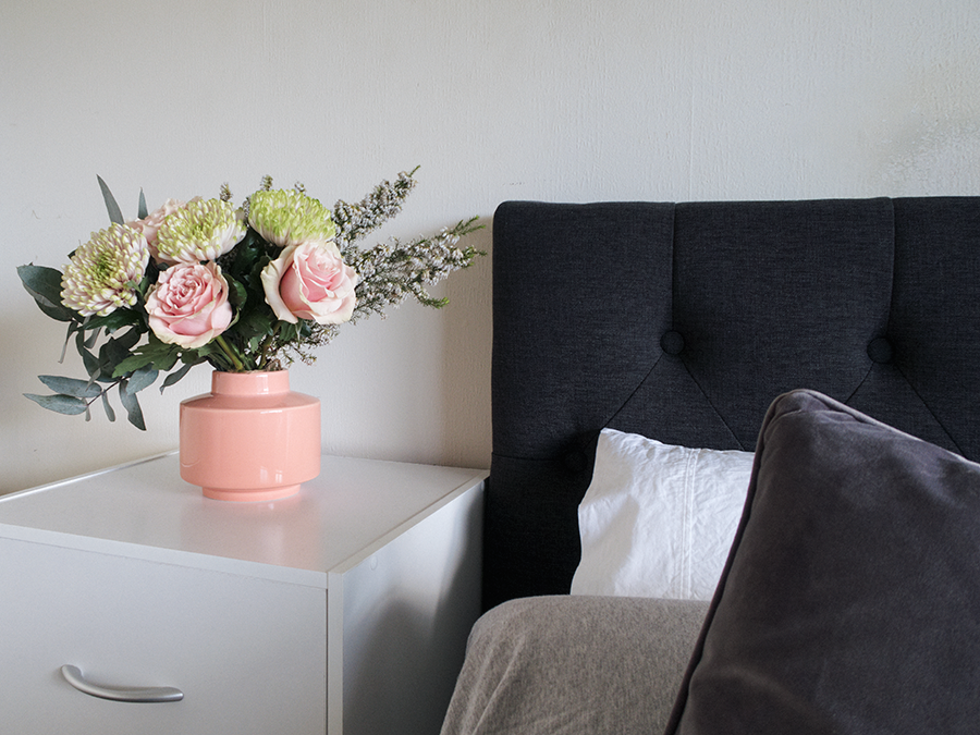 Meagan Kerr's room tour and bedroom makeover on a budget. Headboard from Elite Products, bed from Sleepyhead, bedding from The Warehouse and EziBuy, bedside table and vase from The Warehouse, flowers from Flower Station