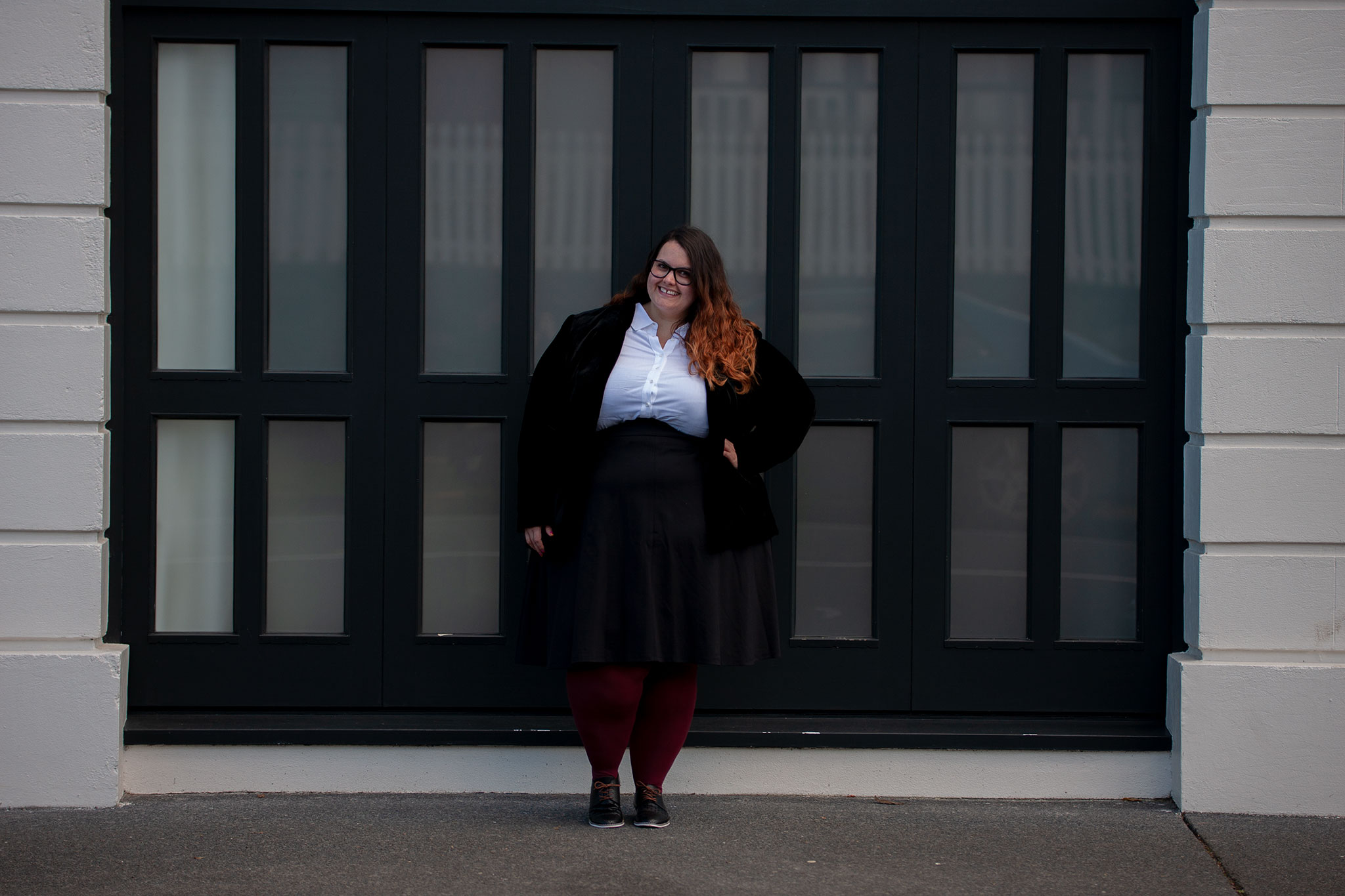 New Zealand plus size blogger Meagan Kerr wears 17 Sundays Basic Longline White Button Up Shirt, Lane Bryant Ponte Circle Skirt, Sara Velvet Blazer from Ezibuy, Pamela Mann 90 Denier Maxi Opaque Plus Size Tights from The Tight Spot, Emerge Anaheim Cut-out Lace Up Court Flat from Ezibuy, Alexa Glasses from Specsavers. Photo by Doug Peters / Ambient Light