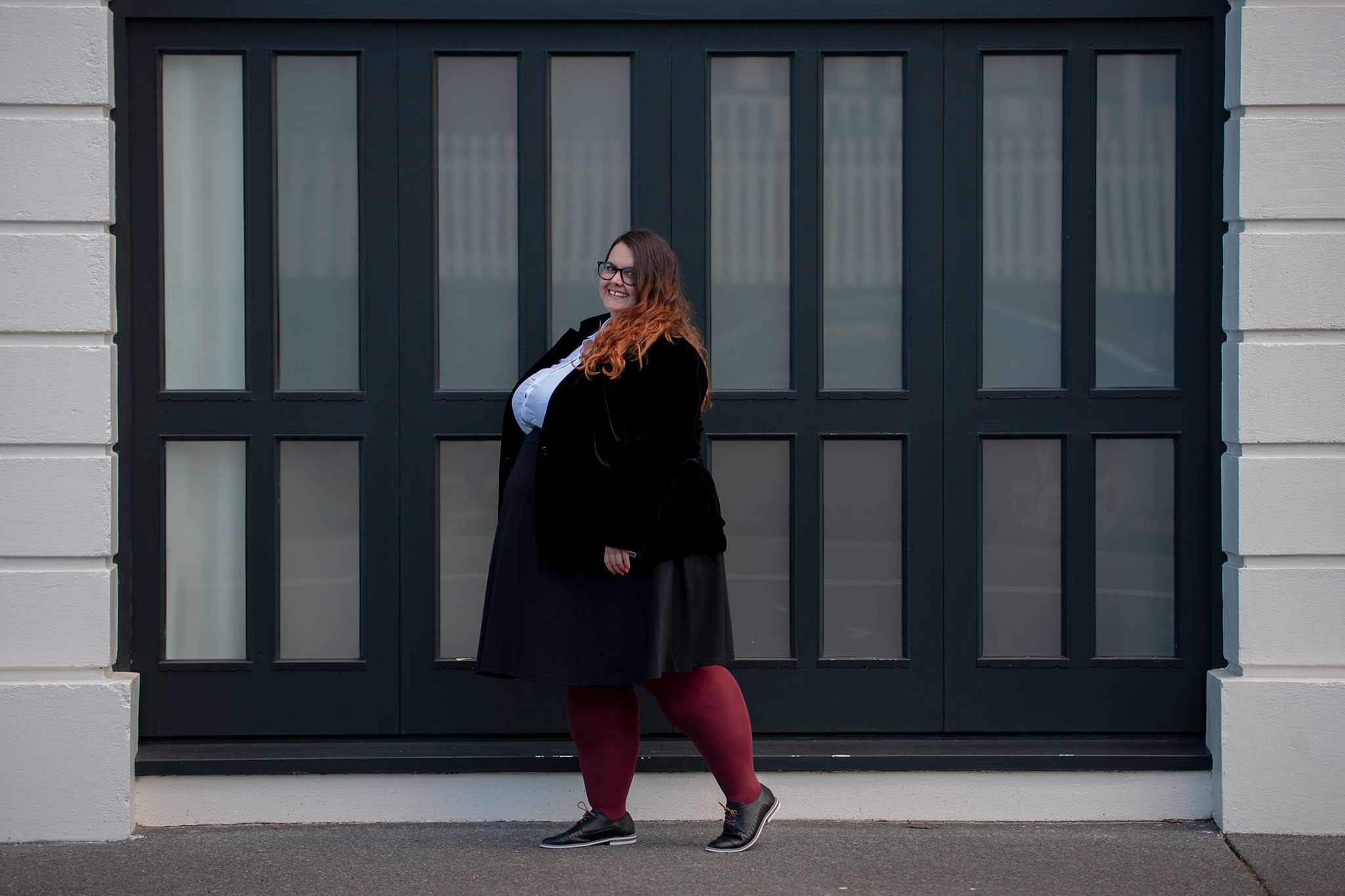 New Zealand plus size blogger Meagan Kerr wears 17 Sundays Basic Longline White Button Up Shirt, Lane Bryant Ponte Circle Skirt, Sara Velvet Blazer from Ezibuy, Pamela Mann 90 Denier Maxi Opaque Plus Size Tights from The Tight Spot, Emerge Anaheim Cut-out Lace Up Court Flat from Ezibuy, Alexa Glasses from Specsavers. Photo by Doug Peters / Ambient Light