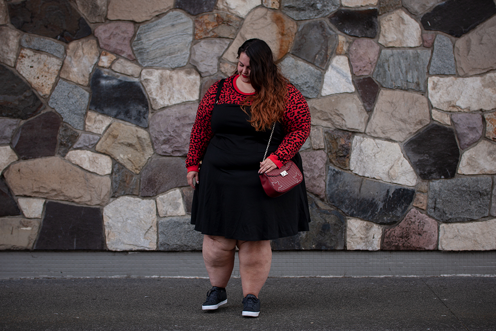 New Zealand plus size fashion blogger Meagan Kerr wears Oasis Curve Animal Jacquard Sweater, Ponte Pinafore, adidas Daily Qt Sneakers and Red Studded Saddle Bag from Simply Be