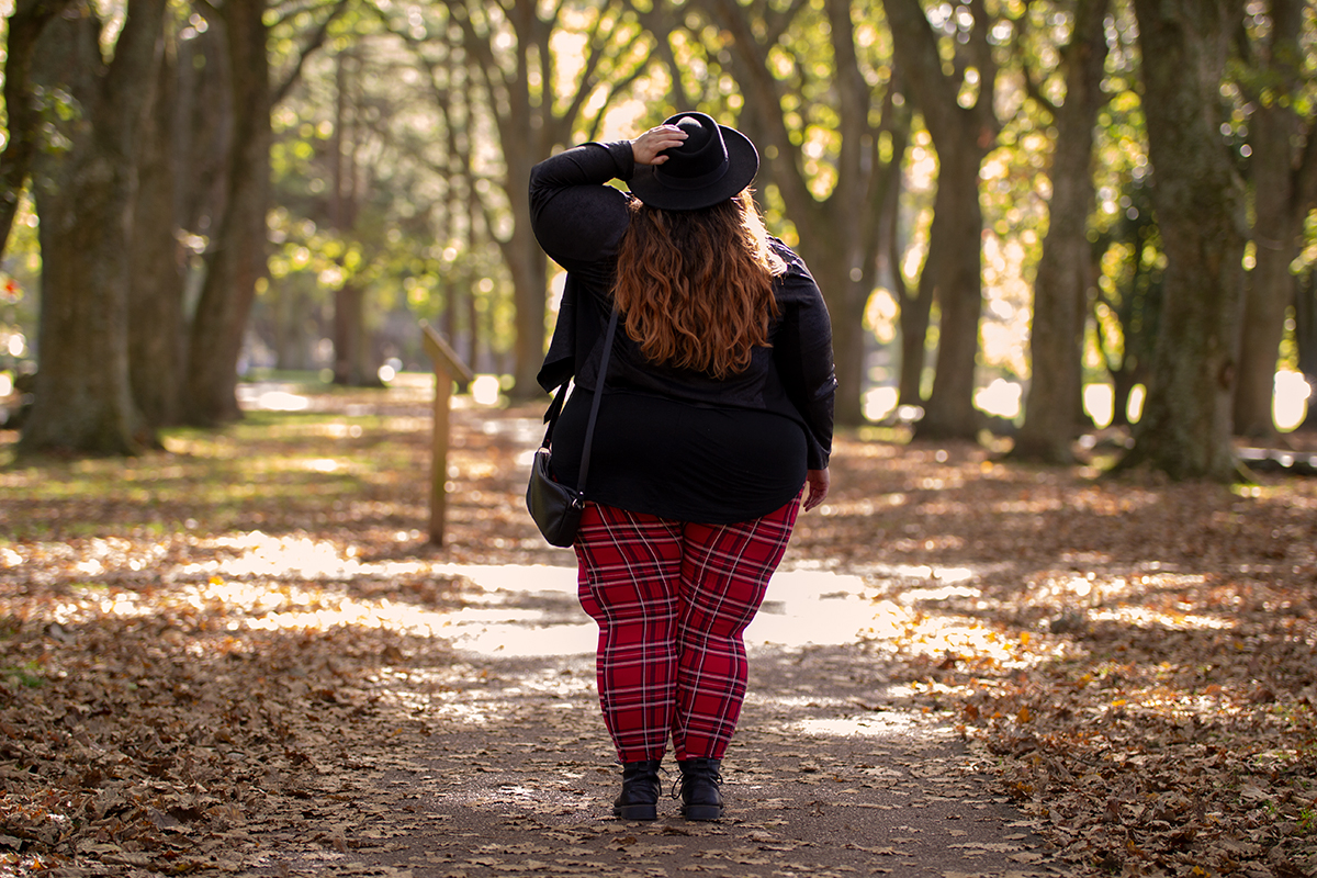 New Zealand plus size fashion blogger Meagan Kerr wears V-Neck Tunic Tee from Torrid, boohoo Plus Tartan Leggings, Snap Short Jacket from Taking Shape, Limited Edition Lecester Boots from Number One Shoes, ASOS DESIGN Wide Brim Pork Pie Hat from ASOS and Winona Crossbody Bag from Velvet Heartbeat