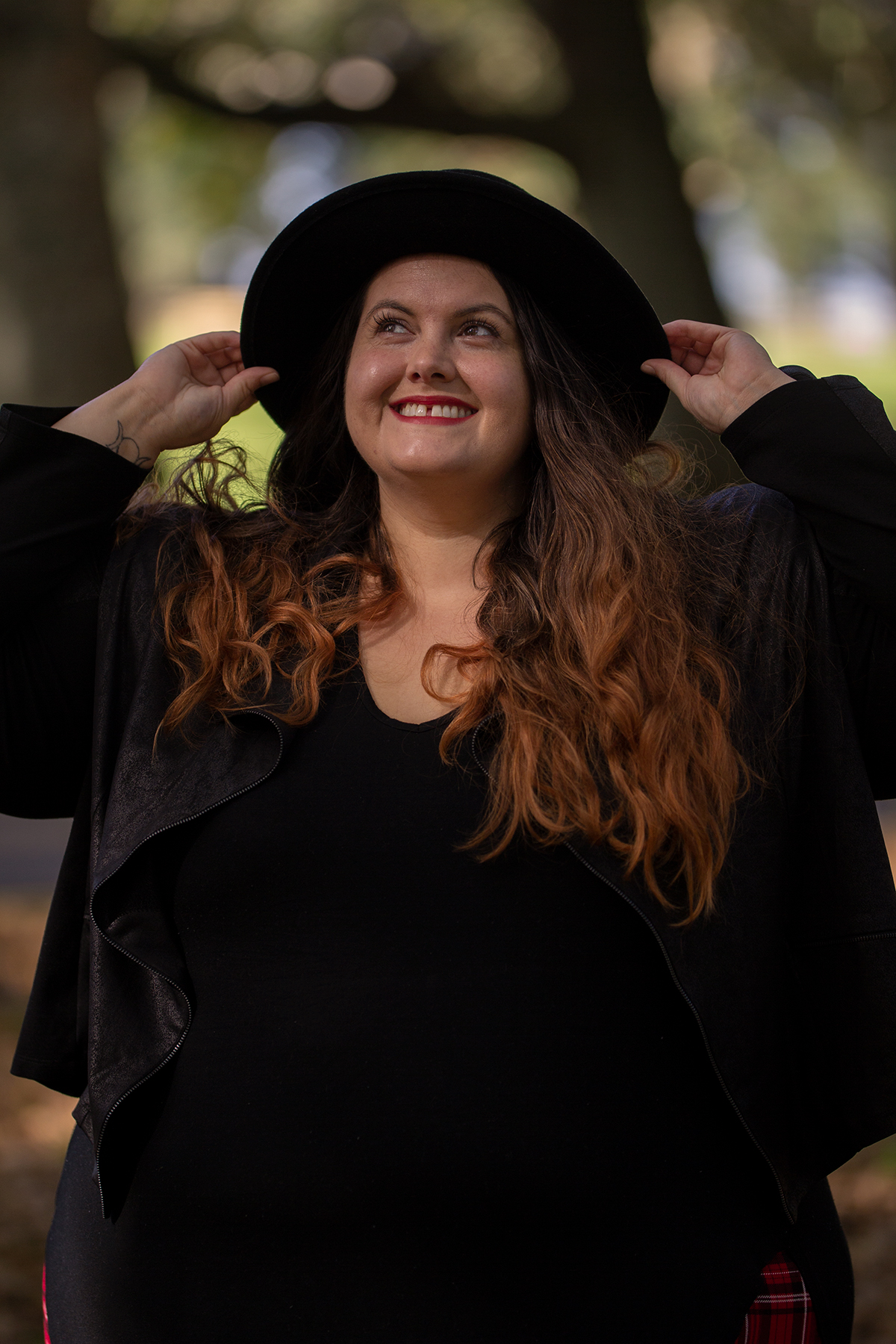 New Zealand plus size fashion blogger Meagan Kerr wears V-Neck Tunic Tee from Torrid, boohoo Plus Tartan Leggings, Snap Short Jacket from Taking Shape, Limited Edition Lecester Boots from Number One Shoes, ASOS DESIGN Wide Brim Pork Pie Hat from ASOS and Winona Crossbody Bag from Velvet Heartbeat