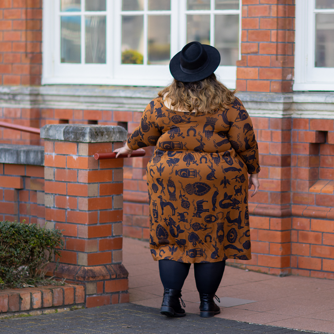 New Zealand plus size fashion blogger Meagan Kerr wears Made590 Sweeney Dress in Charmed, Snag Tights in black, ASOS DESIGN Pork Pie Hat from ASOS and Limited Edition Lecester Boots from Number One Shoes