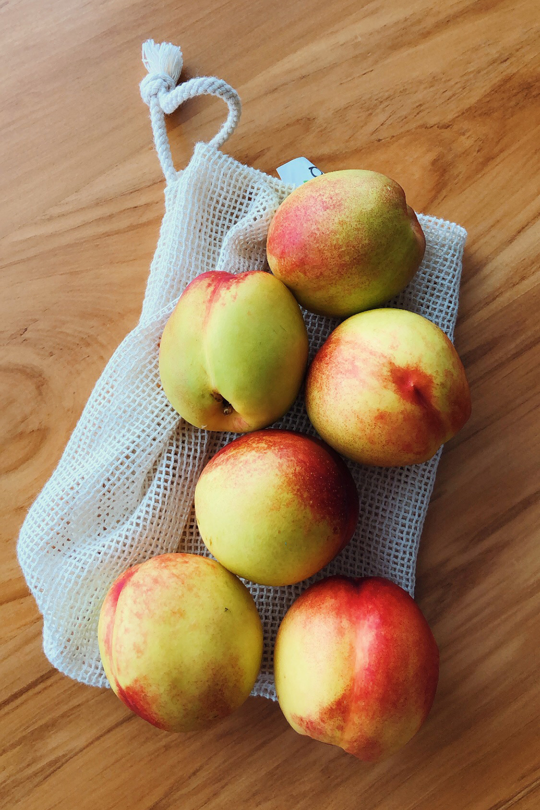 Reusable produce bag with fresh nectarines
