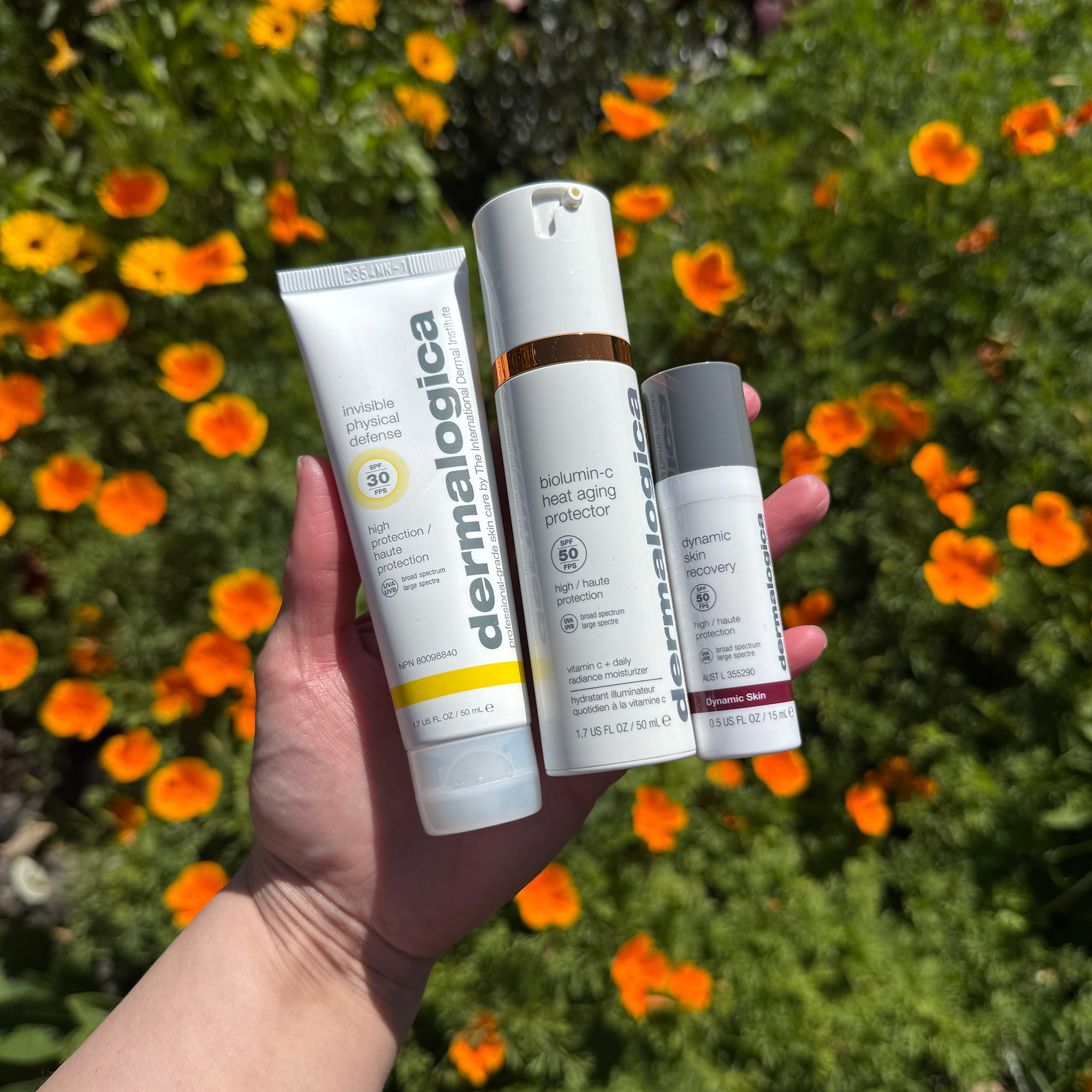 Meagan's hand holding some of her favourite Dermalogica SPF products